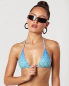 Woman wearing a blue triangle bikini  tusea